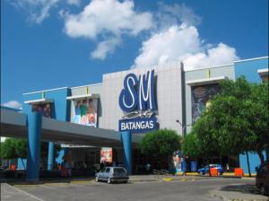 a shopping center with a car parked in front of it at SCJ 1 Fully Furnished Home near SM Batangas in Batangas City