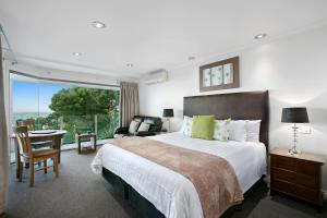 a bedroom with a large bed and a large window at Arthurs Views in Arthurs Seat