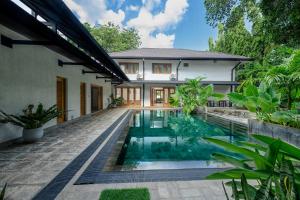 an external view of a house with a swimming pool at Aryana Boutique Hotel in Anuradhapura
