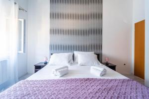 a bedroom with a large bed with two pillows at Apartman Debora sa privatnim bazenom in Pula