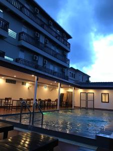 a hotel with a swimming pool at night at Jasmine Vangvieng Hotel in Vang Vieng