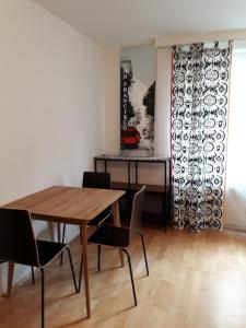 a dining room with a wooden table and chairs at cute Metro U4 in Vienna