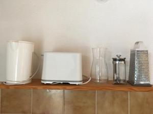 a shelf with two toasters and other appliances on it at Studio Alphabet in Chambéry