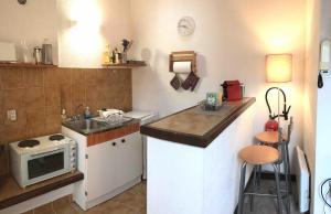 a small kitchen with a sink and a microwave at Studio Alphabet in Chambéry