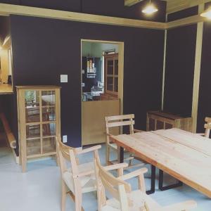 a dining room with a wooden table and chairs at Guesthouse Kazenowa in Asahi +12 photos
