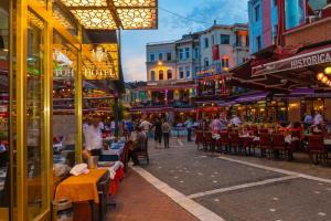 a street with tables and chairs and people walking down a street at Golden Sand Hotel in Istanbul