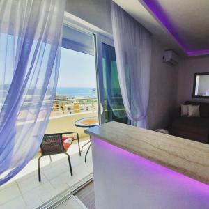a room with a counter with a view of the ocean at Panorama Petrovac in Petrovac na Moru