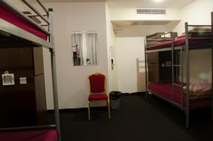 a small room with a bunk bed and a desk at 790 on George Backpackers in Sydney