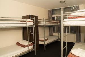 a room with several bunk beds in a dorm at 790 on George Backpackers in Sydney