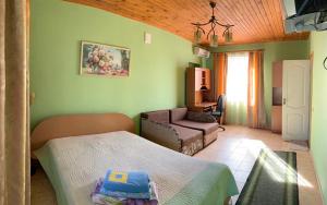 a room with two beds and a couch in it at Solnechnaya 1109 in Zatoka