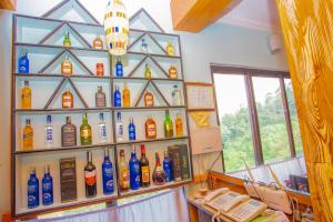 a display of bottles of alcohol on a wall at Sunrise Moon Beam Hotel in Nagarkot