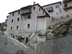 a large stone building on top of a mountain at Archontiko Deligianni in Dimitsana