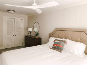 a bedroom with a white bed with a white ceiling at Cru Loft in the Heart of Downtown Knox in Knoxville