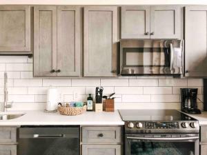 a kitchen with stainless steel appliances and a counter top at Historic Sterchi Loft on Gay St in Knoxville