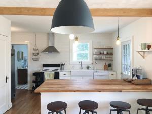 una cocina con una encimera grande con taburetes. en 1940's Bungalow near Downtown & UT Campus, en Knoxville