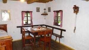 a dining room with a wooden table and chairs at Homestay Kapl in Ledinek