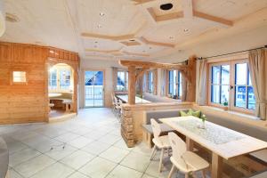 a dining room with a table and chairs and windows at Florineum in Weyregg