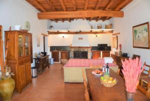 a living room with a dining table and a kitchen at Can Vich Petit in Sant Carles de Peralta