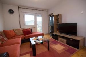 a living room with a couch and a flat screen tv at CasaBlanca in Trebinje