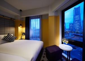Postel nebo postele na pokoji v ubytování Hotel Resol Yokohama Sakuragicho