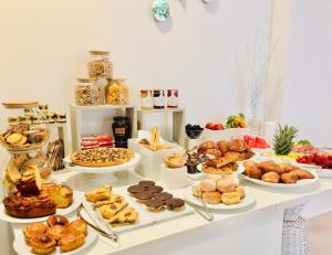 a table filled with different types of pastries and desserts at Piccadilly Rooms Restaurant and Beach in Santa Maria al Bagno