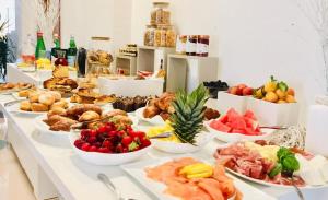 a buffet of different types of food on a table at Piccadilly Rooms Restaurant and Beach in Santa Maria al Bagno