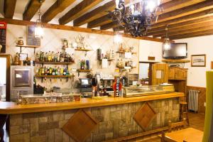 a bar in a restaurant with a counter at El Andarrio in Buitrago del Lozoya
