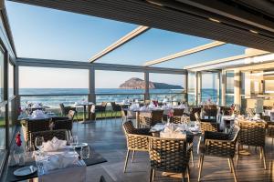 a restaurant with a view of the ocean at Porto Platanias Beach Luxury Selection - Adults Only in Plataniás