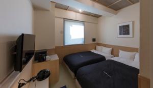 Letto o letti in una camera di Kamon Hotel Namba