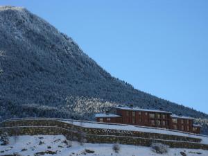 a snow covered mountain with a train on it at Obaga Blanca & Spa in Canillo
