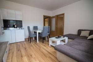 a living room with a couch and a table at CasaBlanca in Trebinje