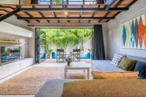 a living room with a couch and a table at Berawa Loft by Hombali in Canggu