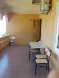 a room with a table and chairs and a window at House Anna in Gonio