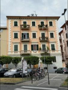 a large building with bikes parked in front of it at Affittacamere Casa Dane' in La Spezia