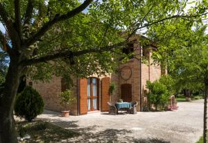 a brick building with a bench in front of it at ValleChiara B&B in Recanati +35 photos