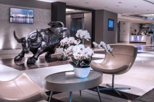 a lobby with a statue of an elephant and chairs at M Hotel Singapore City Centre in Singapore