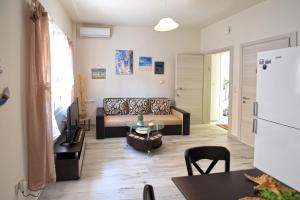 a living room with a couch and a table at Blue Sea Y in Kavála