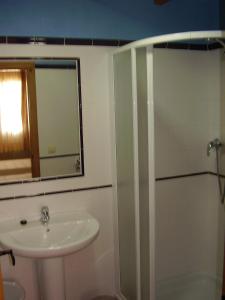 a bathroom with a shower and a sink and a mirror at Casa De Los Diezmos in Alborge