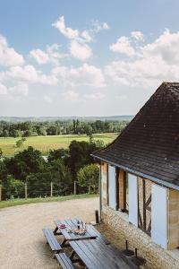 a picnic table in front of a building at Gîte du Domaine de Coutancie in Prigonrieux