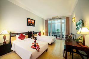 Voodi või voodid majutusasutuse Hoi An Beach Resort toas
