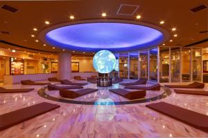a lobby with a blue ceiling and a globe on the floor at Spa World HOTEL&RESORT in Osaka