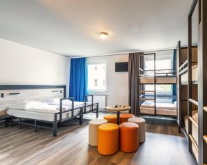 a bedroom with a bed and two bunk beds at a&o Berlin Hauptbahnhof in Berlin