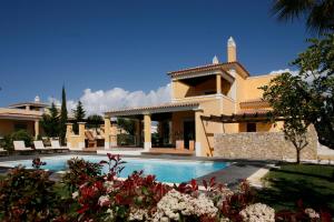 a large house with a swimming pool in front of it at Cascade Wellness Resort in Lagos