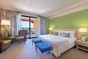 a hotel room with a large bed and a balcony at Cascade Wellness Resort in Lagos