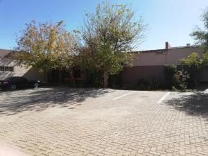 a car parked in a parking lot next to a building at Anandi Guesthouse Mariental in Mariental