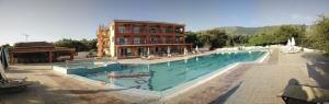 a large swimming pool in front of a building at Ζante Dolphin in Alykes