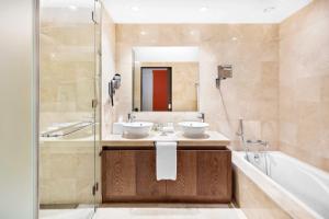 a bathroom with two sinks and a shower at Cascade Wellness Resort in Lagos