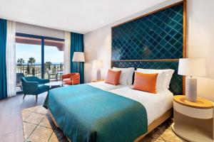 a hotel room with a large bed and a balcony at Cascade Wellness Resort in Lagos