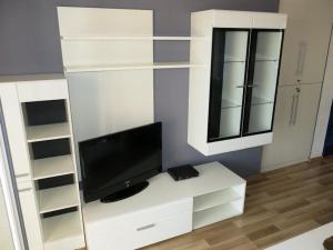 a living room with a tv on a white desk at Apartments Elenora in Brist