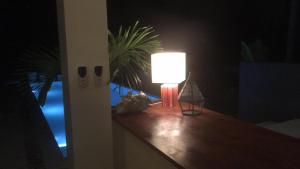 a lamp on a table in a room at night at La Villa Noi in Ban Ko Khwan